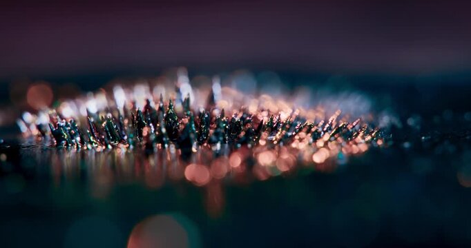 A captivating video shows metal particles reacting to magnetism on a dark backdrop, enhancing motion graphics and visual effects, and inspiring artists for various creative projects