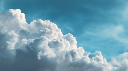 Dramatic white cumulus clouds against bright blue sky