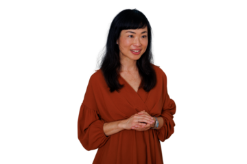 Asian woman thinking and smiling, showing confidence and expressiveness, with a professional posture and transparent background