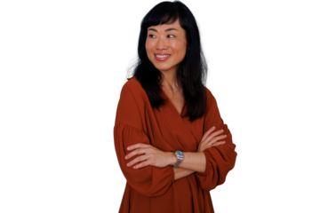 Asian businesswoman smiling with arms crossed, looking away, confident professional portrait, transparent background