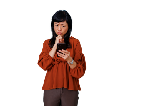 Asian woman feeling confused and worried, looking at smartphone, thinking about a problem, transparent background - Powered by Adobe