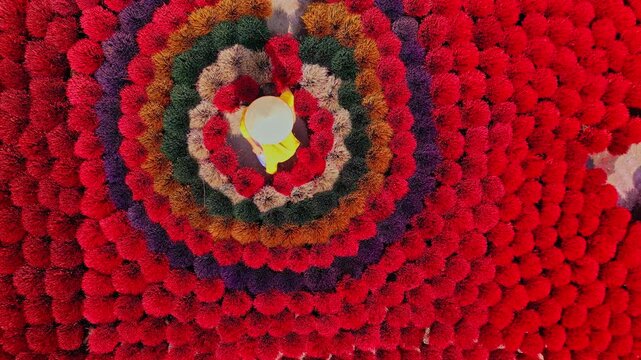 Aerial view of vibrant, colorful incense sticks arranged in concentric circles, creating a mesmerizing visual spectacle, Inciense town, Hanoi, Vietnam.
