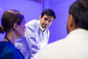 Fototapeta premium Hispanic man doctor teaching, Medical Training Presentation. Hospital Medical Research. Group of Doctor, nurse and healthcare professional meeting sitting boardroom, Planning and brainstorming health