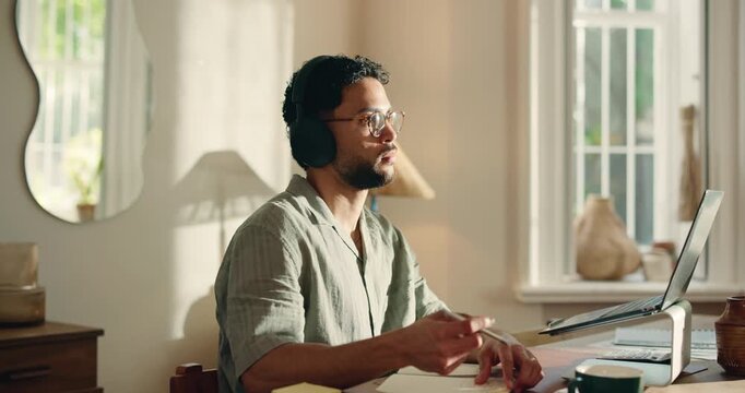 Laptop, man and listening with headphones in home for audio transcription, editing and remote work. Freelancer, transcriber and tech at desk for playback software, video recording and proofreading