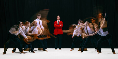 Leader in red jacket facing two opposing groups moving toward each other with motion blur. Concept...