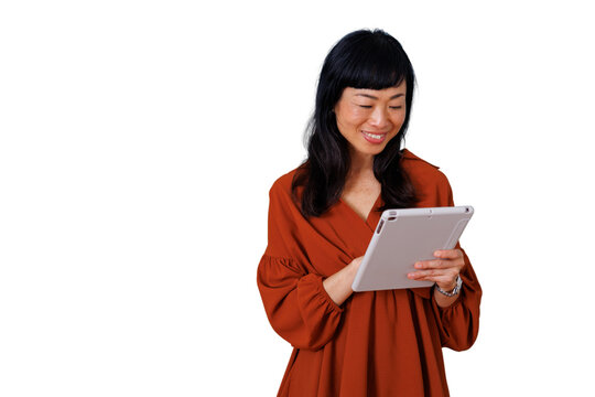 Asian woman smiling and interacting with tablet, browsing online content, showing connectivity and digital lifestyle on transparent background