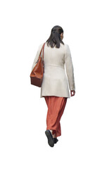 Femme vue de dos marchant en manteau beige, pantalon ample rouille et sac en cuir marron, attitude décontractée le début de printemps