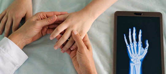 Doctor Examining Patients Hand With X-Ray