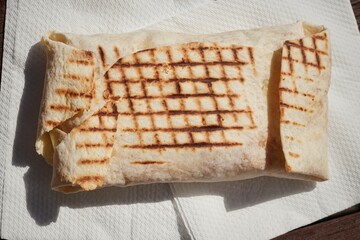 A French Tacos, a popular European fast food, filled with chicken and cheese