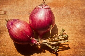 A bunch of raw, whole, red onions
