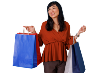 Happy asian woman shopping, carrying colorful shopping bags with transparent background, enjoying sales and consumerism