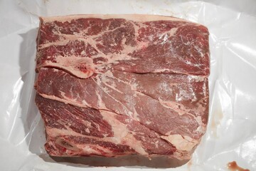 A raw chuck steak, also called a stewing steak