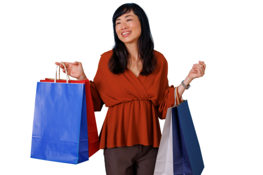 Happy asian woman shopping, carrying colorful shopping bags with transparent background, enjoying sales and consumerism