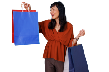 Happy asian woman holding colorful shopping bags after successful retail therapy and sale purchases