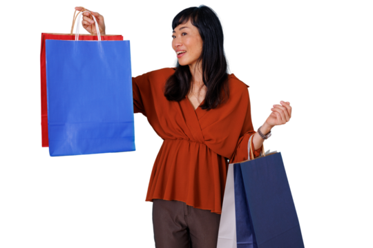 Happy asian woman holding colorful shopping bags after successful retail therapy and sale purchases - Powered by Adobe
