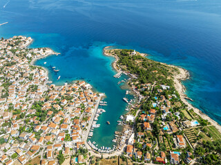 Aerial drone photo of picturesque old town and harbor of Spetses island with emerald crystal clear sea overlooking the Saronic gulf, Greece
