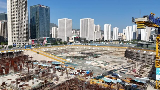 Aerial Construction Site with Tower Cranes and City Skyline