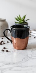 Rustic ceramic coffee cup with copper glaze and handle on a marble surface with scattered coffee beans and a succulent plant