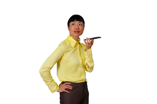 Asian business woman dictating a voice note into her mobile phone, staying connected, using modern communication