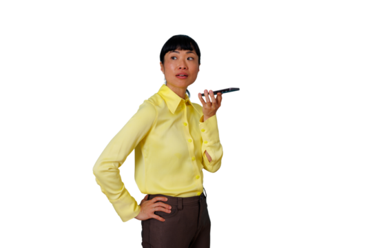 Asian business woman dictating a voice note into her mobile phone, staying connected, using modern communication