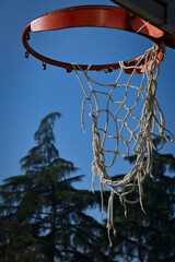 an old basketball hoop in a small city park