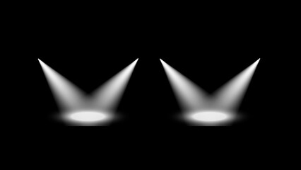 Two bright white spotlights shining down on a dark stage creating dramatic beams of light
