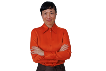 Asian businesswoman with crossed arms smiling at camera, confident professional in orange shirt, transparent background
