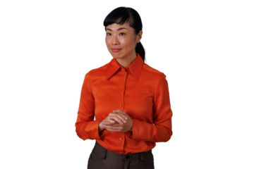 Asian business woman standing, listening attentively with clasped hands, wearing orange blouse on transparent background