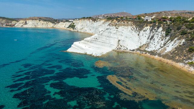 Aerial view of the Scala dei Turchi (Stair of the Turks or Turkish Steps) on the coast of Realmonte, near Agrigento, Sicily, Italy. It's a rocky cliff and tourist attraction. The sea is azure, crystal