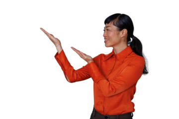 Asian woman presenting an idea, smiling and gesturing with hands showing copy space on transparent background