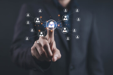 Businessman touching a digital network of people icons representing team connection HR management recruitment, communication and modern business networking for organizational growth and collaboration.