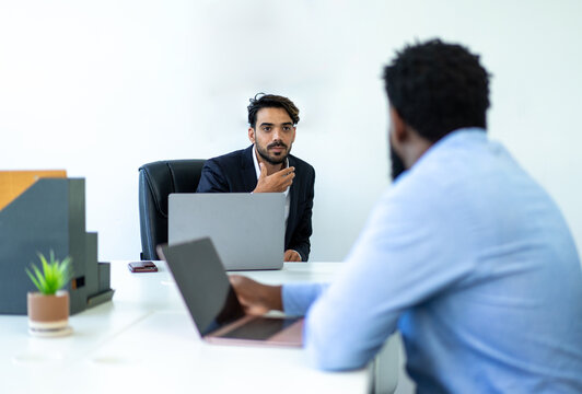 businessman colleague discuss explain budget performance planning, sharing idea for cost reduction, business people man diverse employee coworker in formal suit meeting in finance office