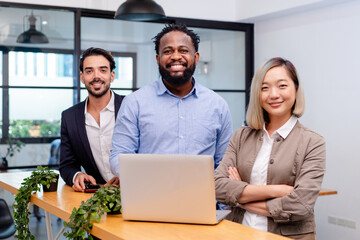 team of multiethnic colleague discuss business topic in creative green office co working space, group of business people coworker casual online meeting on tablet standing desk modern office workplace