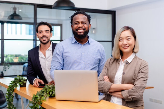 team of multiethnic colleague discuss business topic in creative green office co working space, group of business people coworker casual online meeting on tablet standing desk modern office workplace - Powered by Adobe