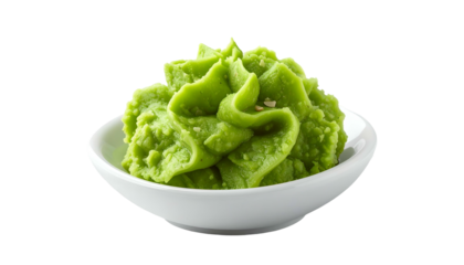 Bright green wasabi paste atop small, plain white dish