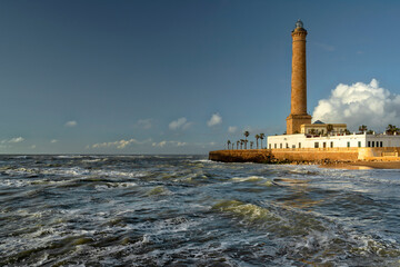 Fototapeta premium Chipiona, Spain. Chipiona Lighthouse on the Ocean Shore. Sea travel and tourism, Atlantic 
