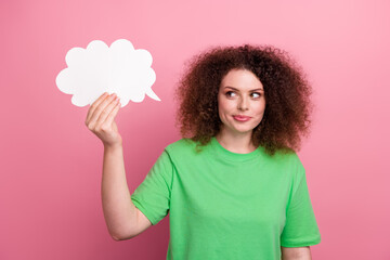Brunette woman in a green t shirt holds white speech bubble pink background showing playful expression lifestyle advertising fashion imagery