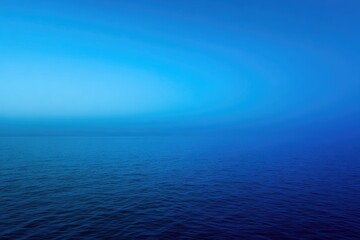 Obraz premium Calm ocean meets clear sky, serene and seamless. A gradient of blues offers tranquility