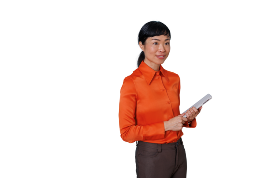Asian businesswoman holding a tablet, looking confident, professional, and smiling on transparent background