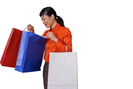 Woman feeling happy after shopping, looking inside a blue paper bag, transparent background for easy use