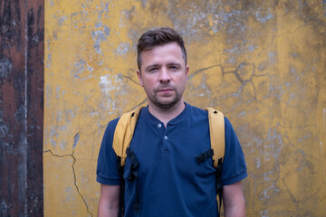 Portrait of a European Man by a Wall