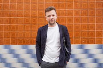 Portrait of a European Man by a Wall