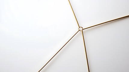 Minimalist gold metal frame. The metallic framework is set against a clean white background, showcasing intersecting lines and geometric symmetry with a central ring.