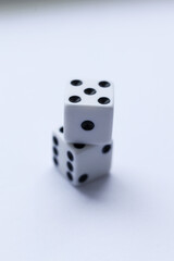 Two white dice with black dots on a white background. Close-up.