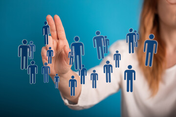 Woman interacting with a network of digital people icons, representing social connection, business, and technol