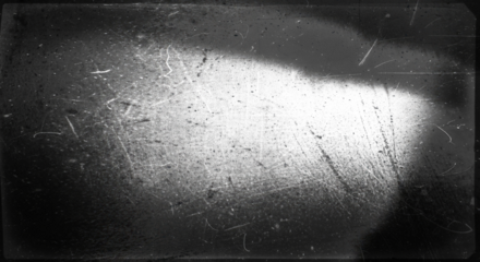 Scratches texture with bright harsh light spot on dark background