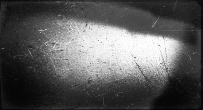 Scratches texture with bright harsh light spot on dark background