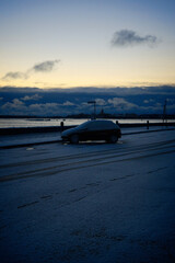 Lonely Car on Parking Lot at Winter Twilight