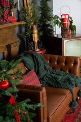 Vintage Living Room decorated for Christmas with brown leather couch and red and green holiday decor