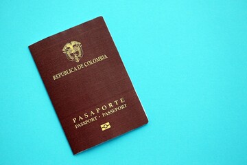 Colombia Republic red passport on light blue table background close up. Concept of travel and tourism